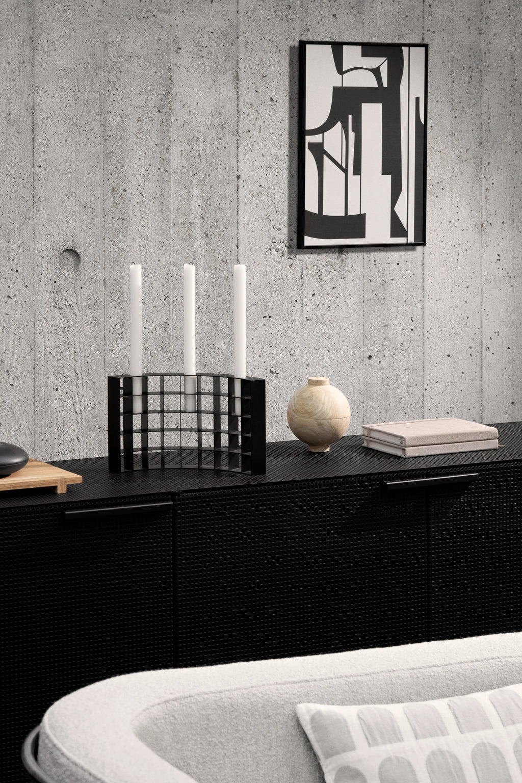 Kristina Dam Mesh Candle Holder, a sleek matte black metal candelabra featuring a striking geometric grid design, capable of holding four taper candles. Its minimalist form and industrial chic aesthetic make it a perfect modern accent for Scandinavian living rooms or contemporary dining table centerpieces.