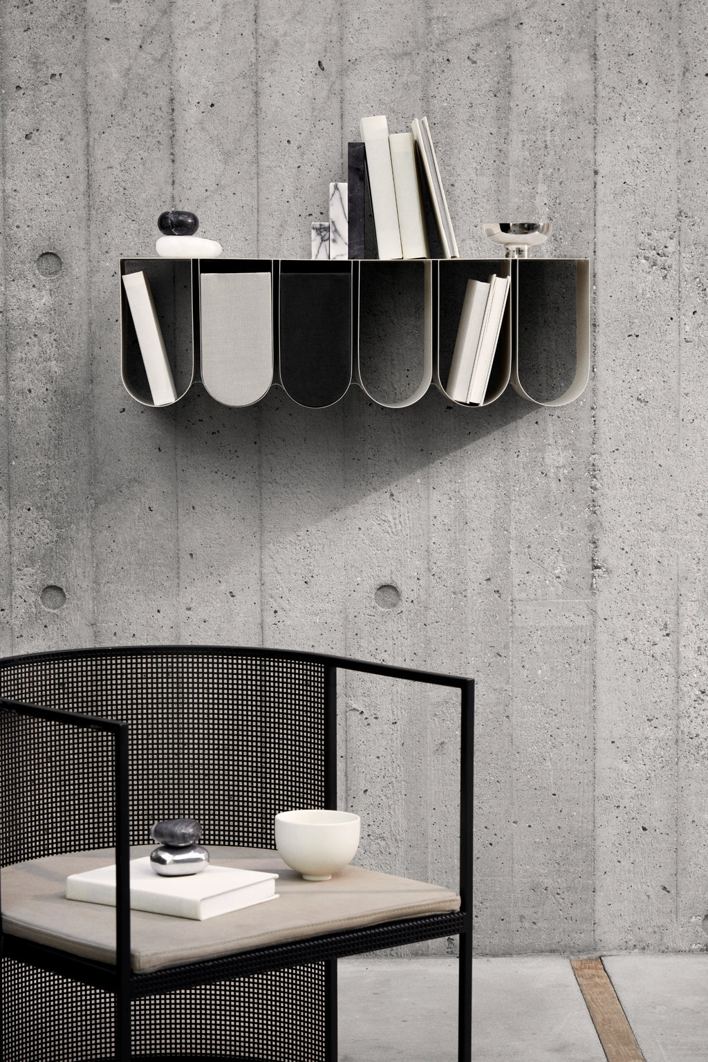 Kristina Dam Curved Wall Shelf, a striking modern minimalist wall shelf crafted from matte black metal with a distinctive wavy profile and multiple arched compartments. This contemporary designer wall shelf offers stylish storage and display for books and decor, perfect for Scandinavian living rooms or industrial chic home offices.