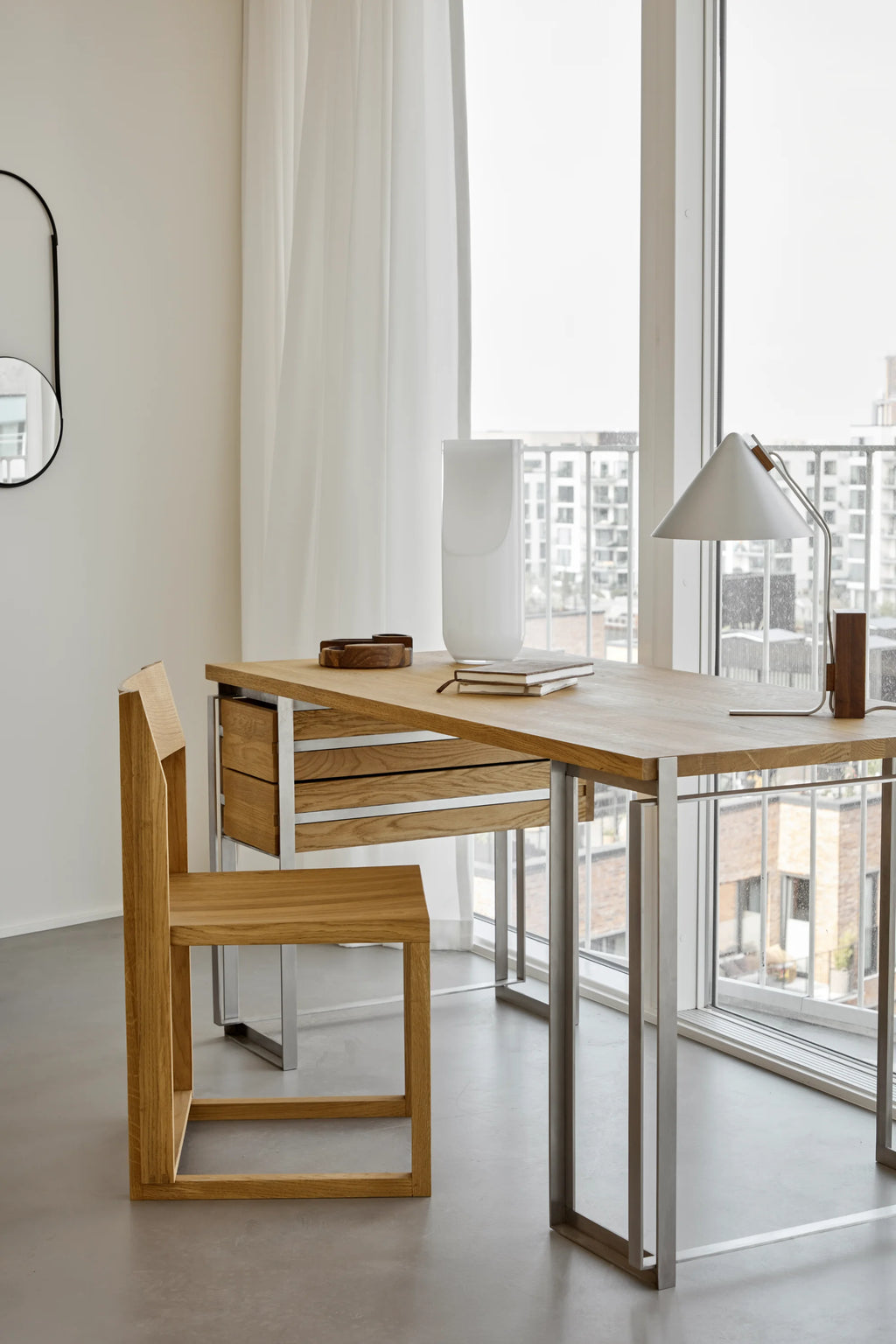 Kristina Dam Outline Desk, a modern minimalist workspace featuring a light natural solid oak tabletop and integrated drawers, supported by a sleek brushed stainless steel frame. This contemporary Scandinavian desk combines warm oak wood grain with cool industrial metal, offering a functional yet stylish design. Perfect as a home office desk or a chic writing table for modern interiors.