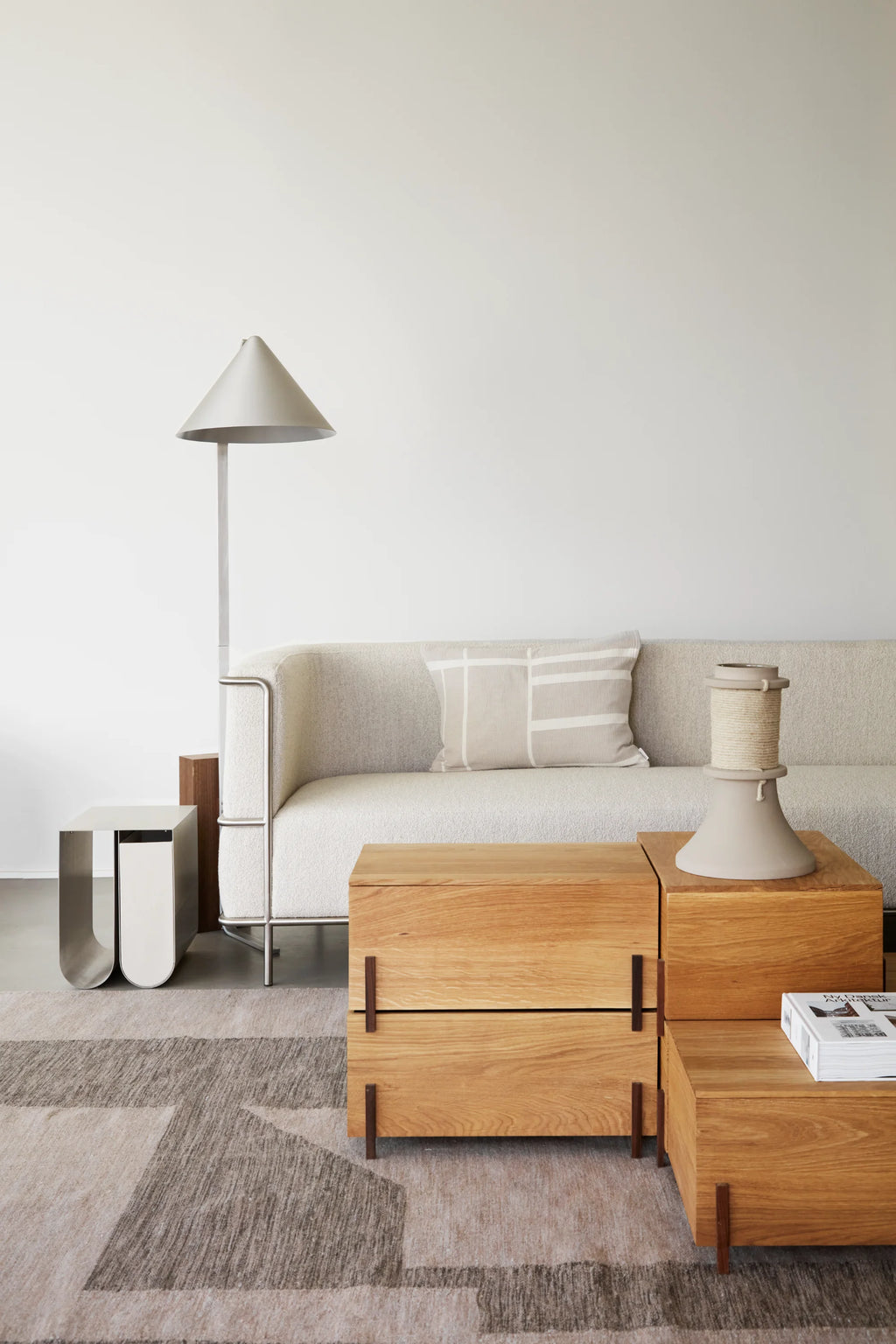 Kristina Dam Stack Storage Box, a versatile collection of rectangular storage boxes crafted from natural solid oak wood with a smooth grain finish and modern minimalist aesthetic. Designed to be stackable, these contemporary oak boxes feature subtle dark bronze metal vertical supports, functioning perfectly as elegant living room storage, a stylish side table, or a unique coffee table for Scandinavian-inspired interiors.