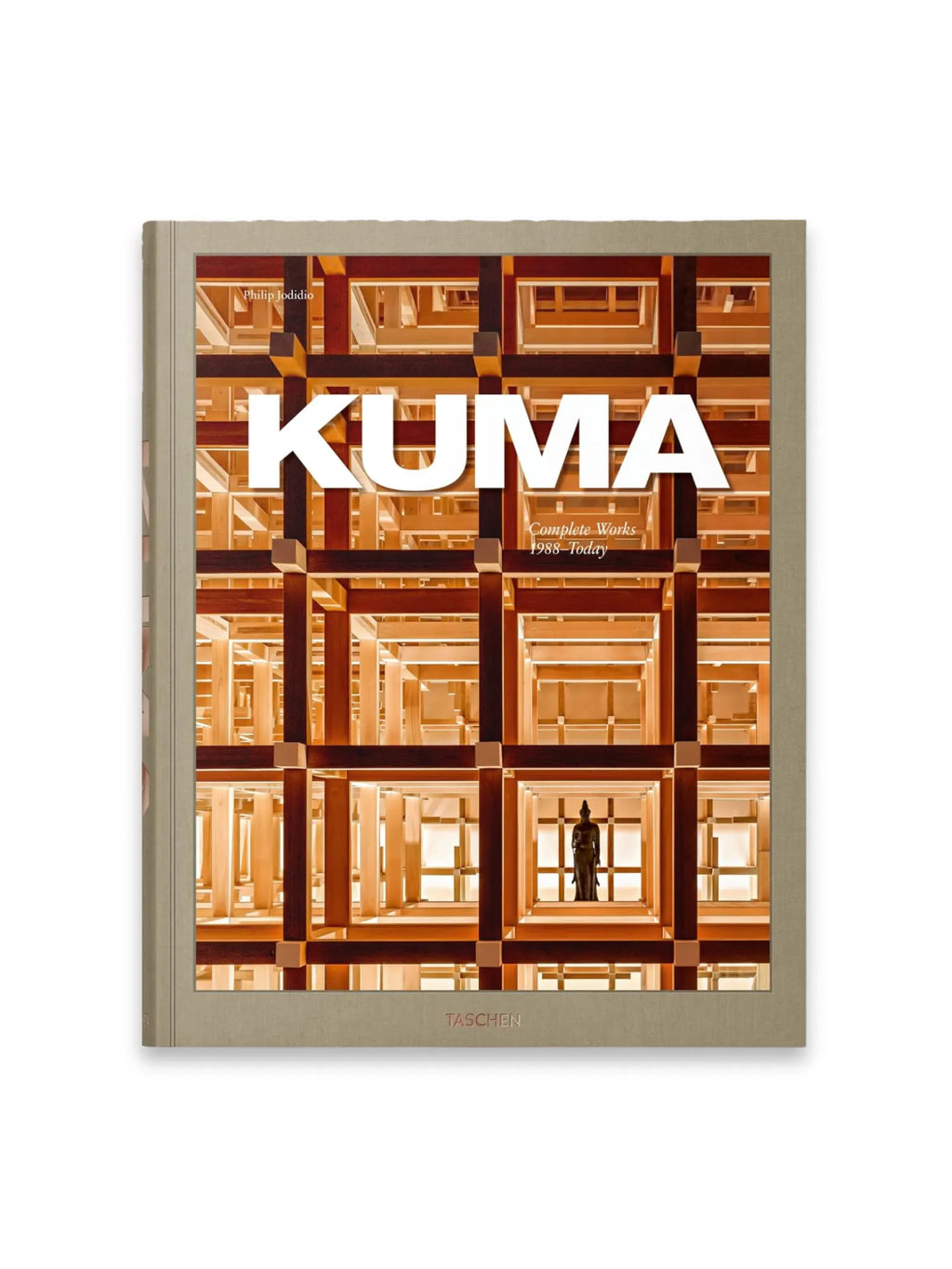 Book Kuma. Complete Works 1988–Today, a large format hardcover book with a textured light brown cover and a striking architectural image. The cover art displays an intricate grid of light and dark brown wooden beams, creating a complex, modern interior design with a dark statue at its base. This comprehensive art and architecture book is perfect for design enthusiasts and students of contemporary Japanese architecture.