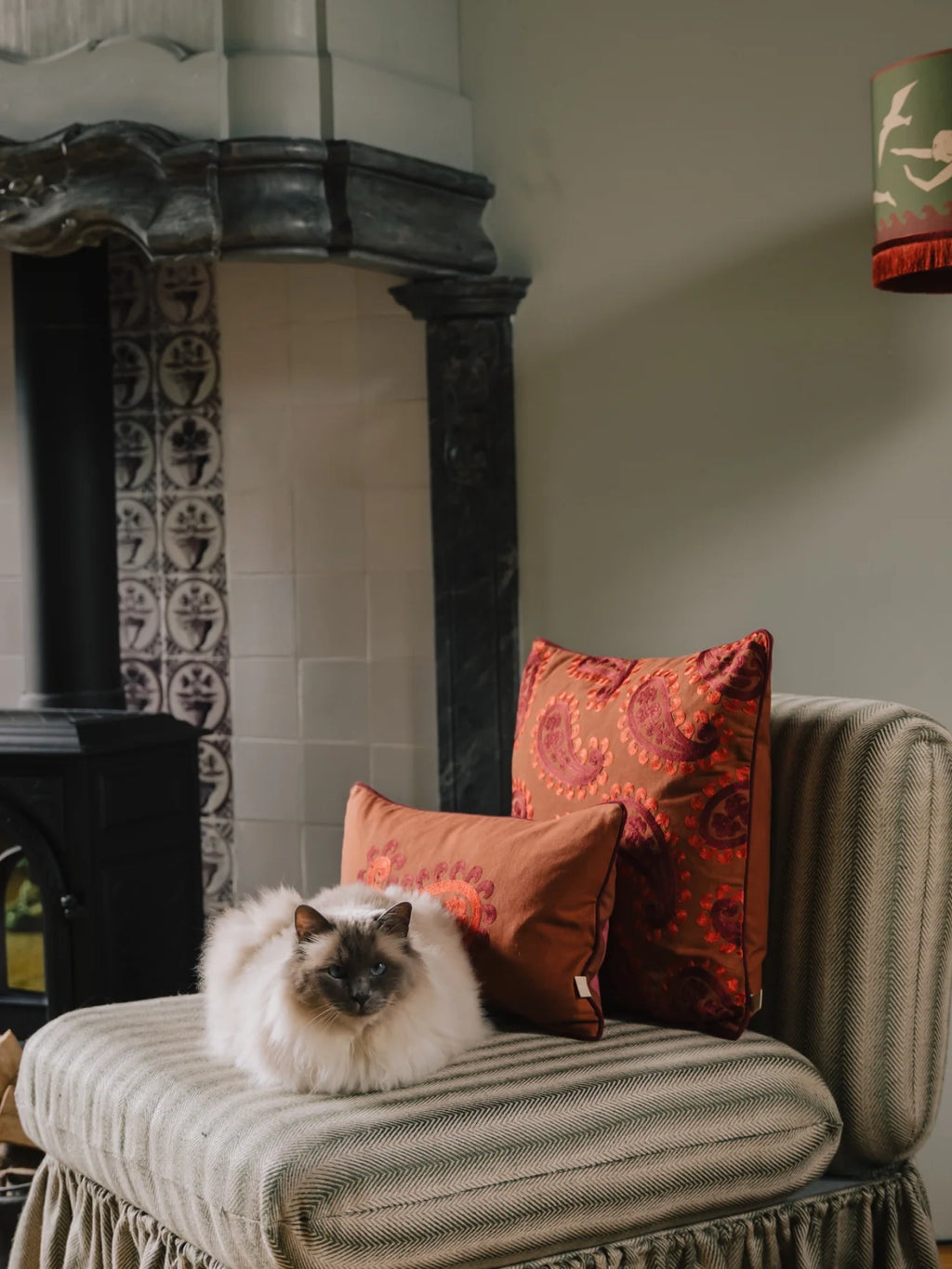 Palais Double Sided Siena Throw Pillow, a richly embroidered terracotta orange cushion featuring an intricate deep red paisley pattern, crafted from a soft, durable fabric with a luxurious texture.