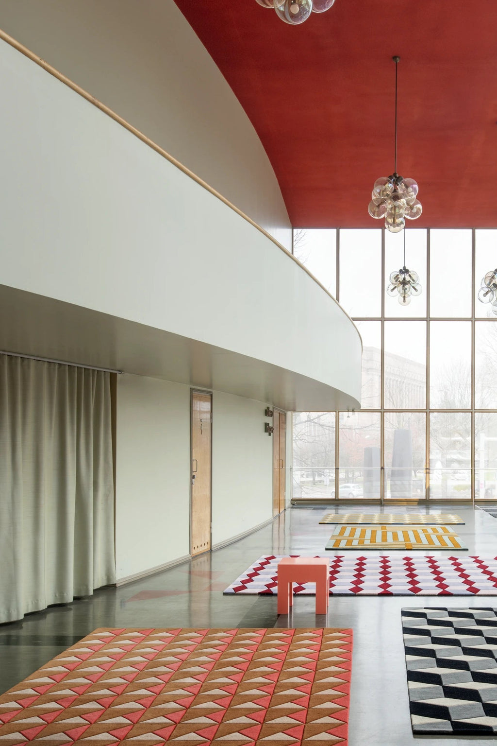 Layered Illusion Wool Rug, featuring a vibrant terracotta, beige, and white geometric triangle pattern. This stylish modern area rug is perfect for adding a statement art deco design to contemporar...