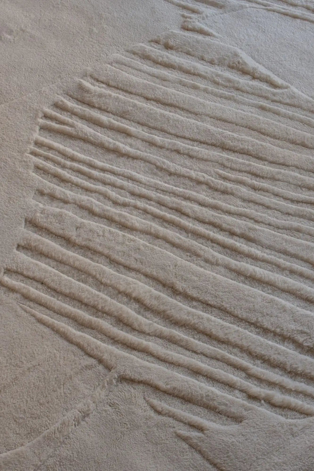 Layered Artisan Guild Wool Rug, a plush beige loop pile rug with a unique abstract striped pattern creating a carved, textured effect. Perfect for adding warmth and sophisticated style to living ro...