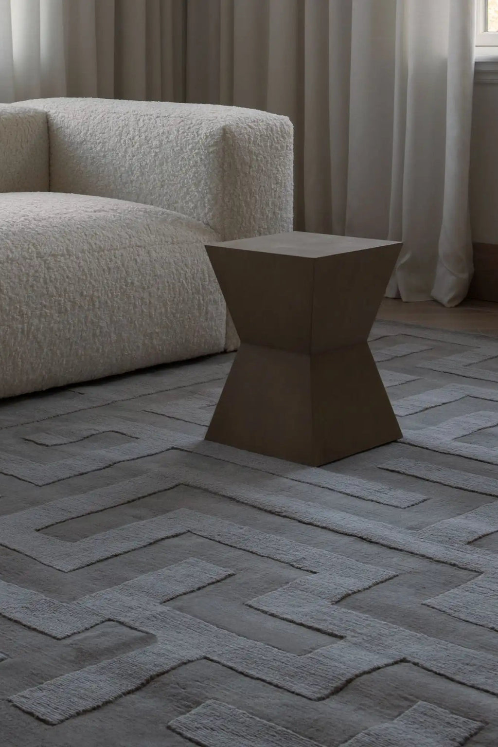Layered Byzantine Grand Wool Rug, a luxurious gray wool rug with a raised geometric labyrinth pattern, showcasing rich texture and depth. Perfect for elevating modern living room decor.