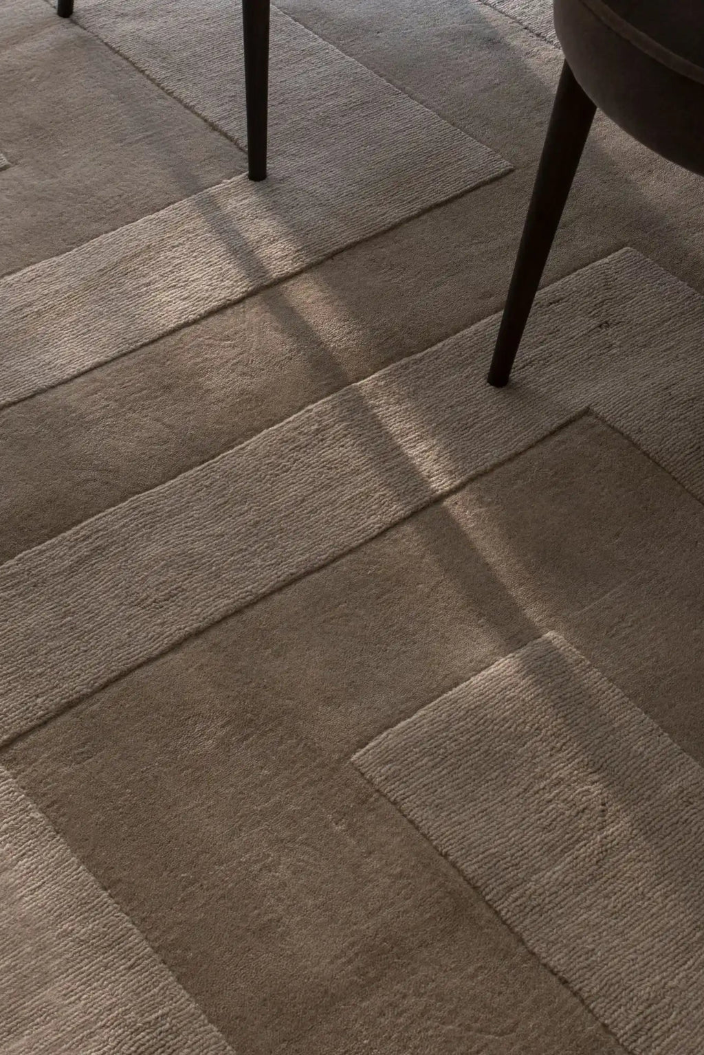 Layered Byzantine Grand Wool Rug, a luxurious brown wool area rug with a subtle geometric pattern created by varied pile heights and textures. Perfect for adding warmth and sophisticated style to a...