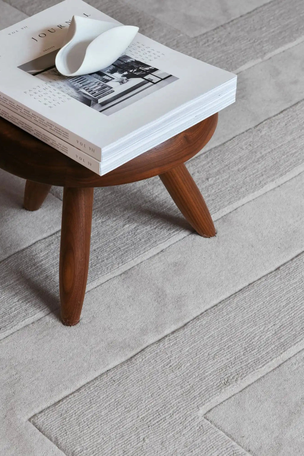 Layered Byzantine Grand Wool Rug, a luxurious light gray textured wool rug with a distinctive geometric pattern of alternating smooth and ribbed stripes. Perfect for adding warmth and sophisticated...