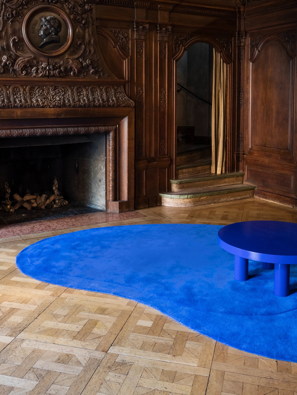 Layered Residue Wool Rug, a vibrant royal blue organic shaped area rug with a plush, hand-tufted wool pile and an irregular, wavy silhouette. This contemporary abstract rug creates a bold focal point, perfect for modern minimalist living rooms, creative studio spaces, or eclectic dining areas.