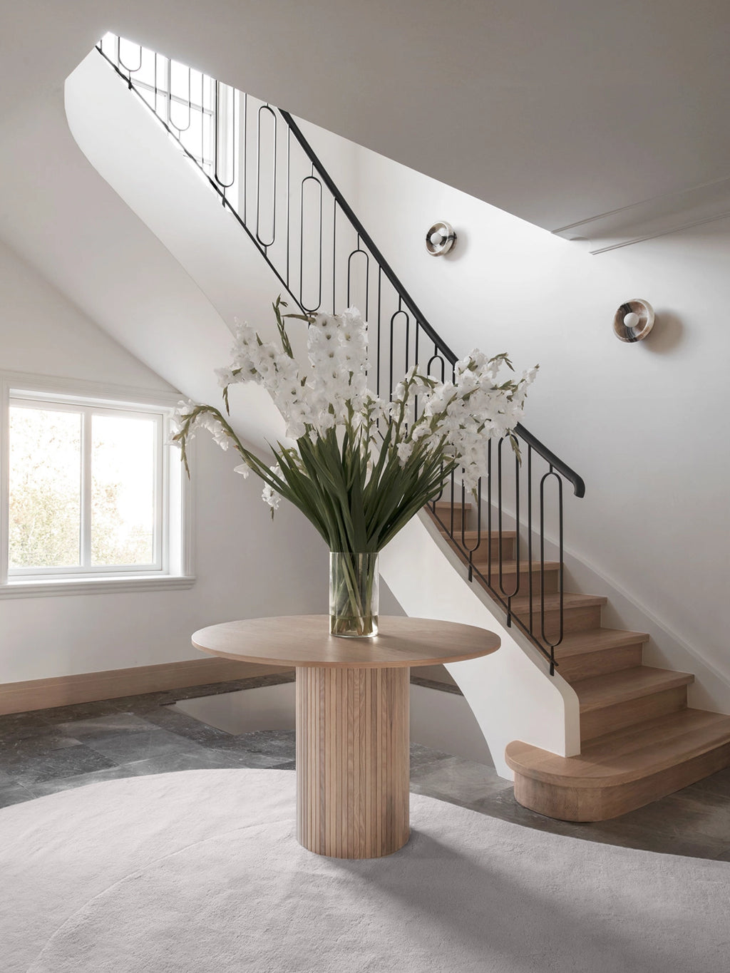 Layered Residue Wool Rug, a round light grey wool area rug featuring a plush, high-pile texture and subtly organic color variations for a soft, inviting feel. This modern minimalist rug is perfect for adding warmth and sophisticated style to an entryway, living room, or Scandinavian-inspired interior.