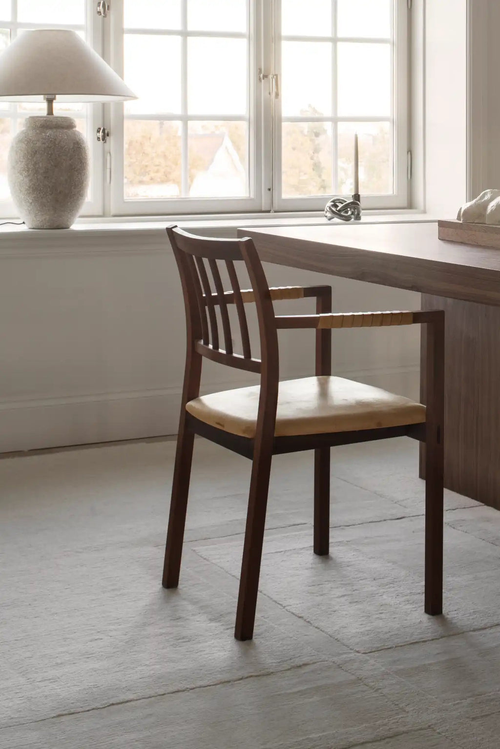 Layered Swedish Grace Wool Rug, a light grey hand-woven wool rug with subtle textured lines, creating a minimalist and elegant floor covering. Perfect for adding warmth and sophisticated style to a...