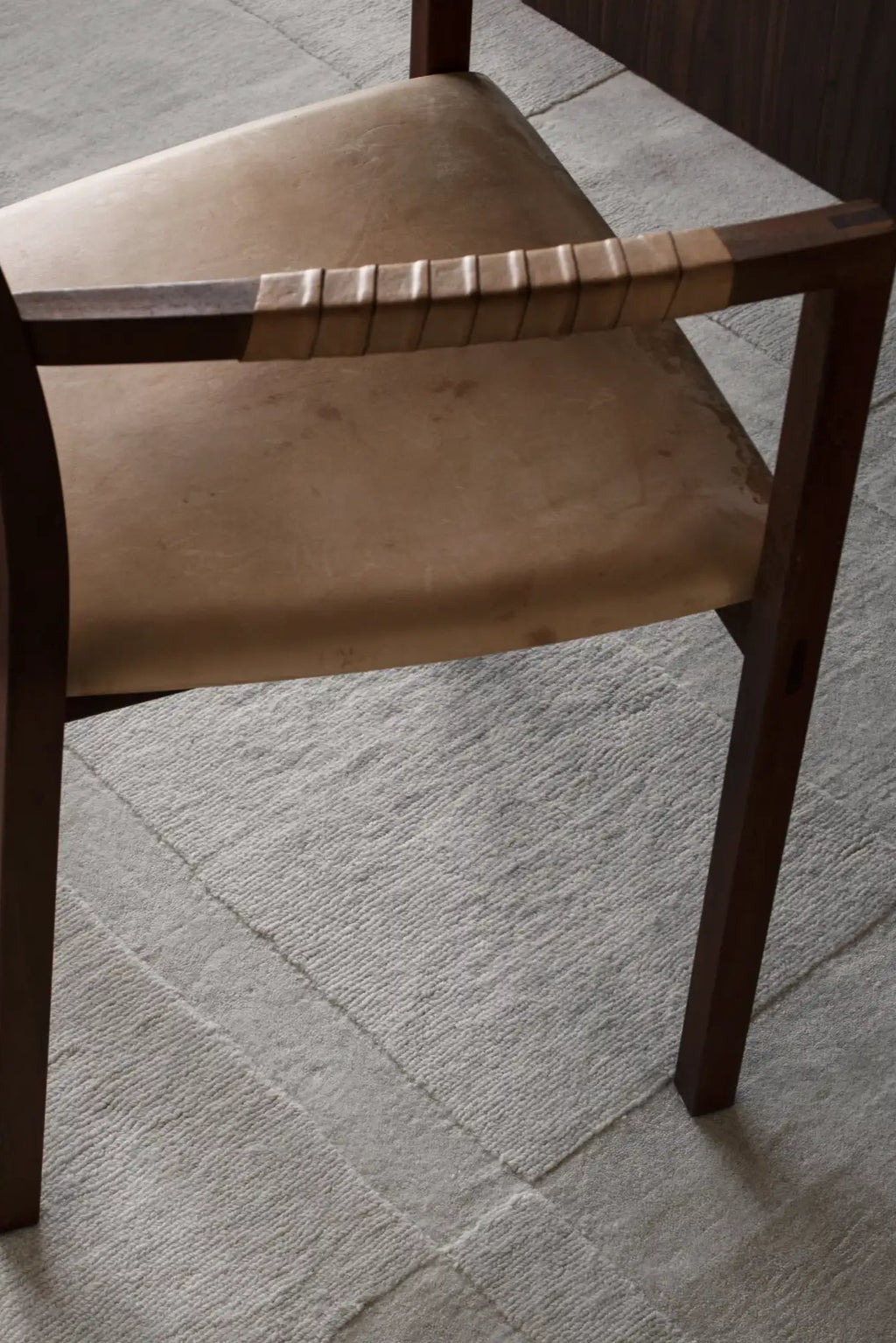 Layered Swedish Grace Wool Rug, a light gray textured area rug with subtle geometric patterns, made from durable wool. Perfect for adding a soft, natural touch to living room or bedroom decor.