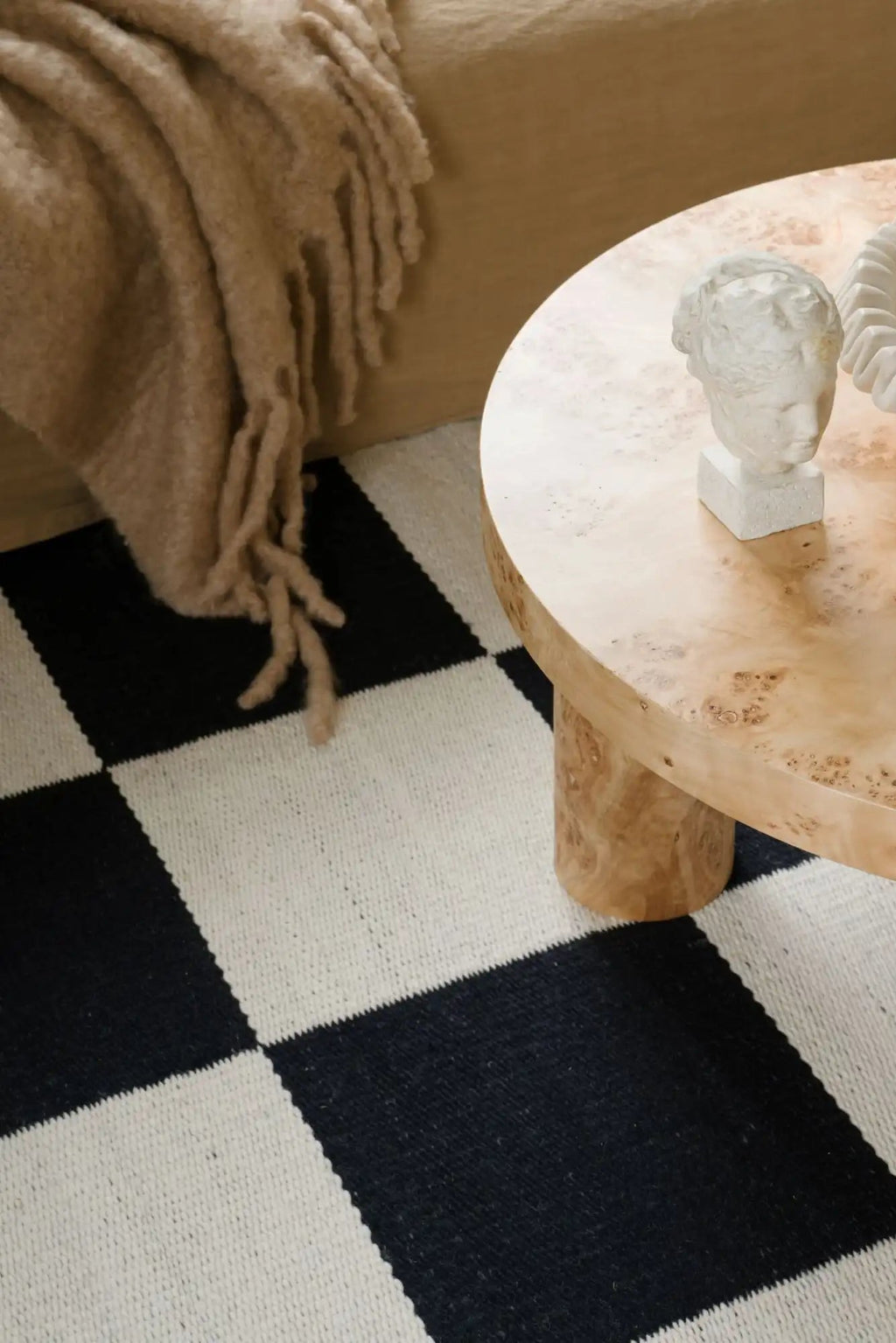 Layered Chess Wool Rug, a stylish black and white checkered floor rug made from durable wool. Perfect for adding a modern, graphic touch to any living room or bedroom.