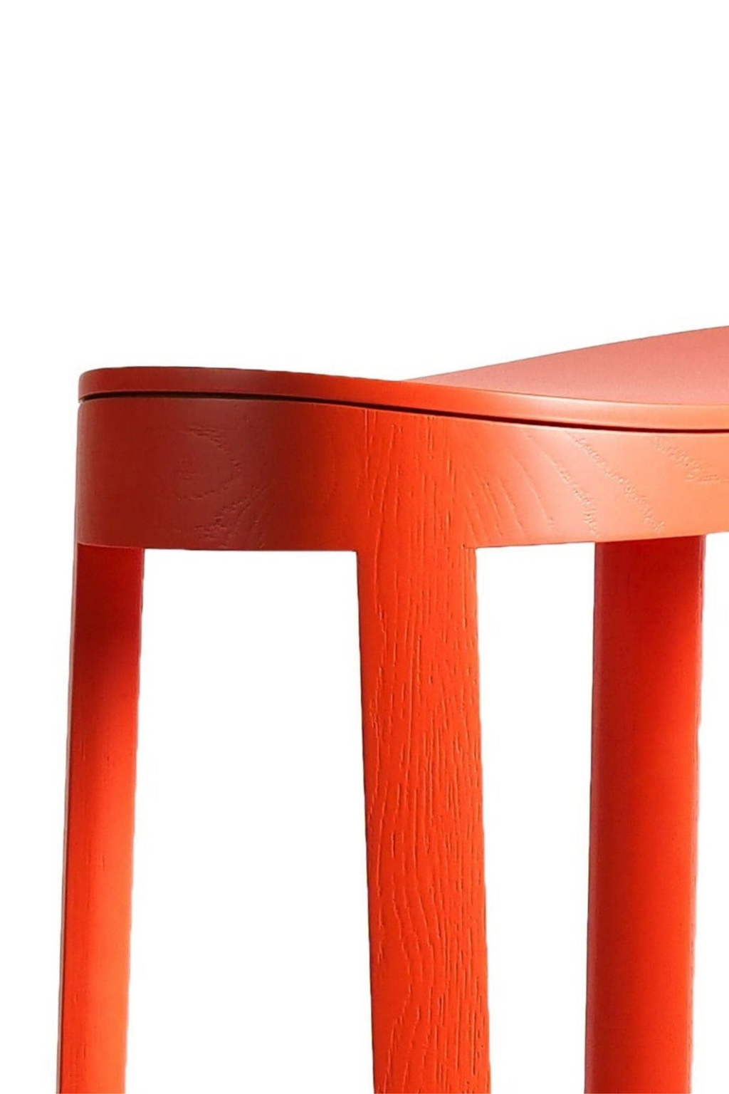 Made by Choice Lammi Bar Stool, a vibrant coral orange solid wood bar stool featuring a smooth, subtly curved round seat and sturdy cylindrical legs with visible wood grain texture.