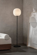Lantern floor lamp standing tall in a modern living room