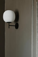 Lantern Wall Lamp featuring classic design with adjustable arm and clear glass panels