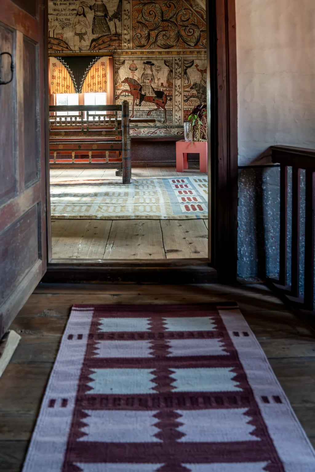 Layered Iris Wool Rug, a burgundy and light grey handwoven wool runner rug featuring a geometric pattern with jagged edges. Perfect for adding warmth and vintage charm to hallways or entryways.