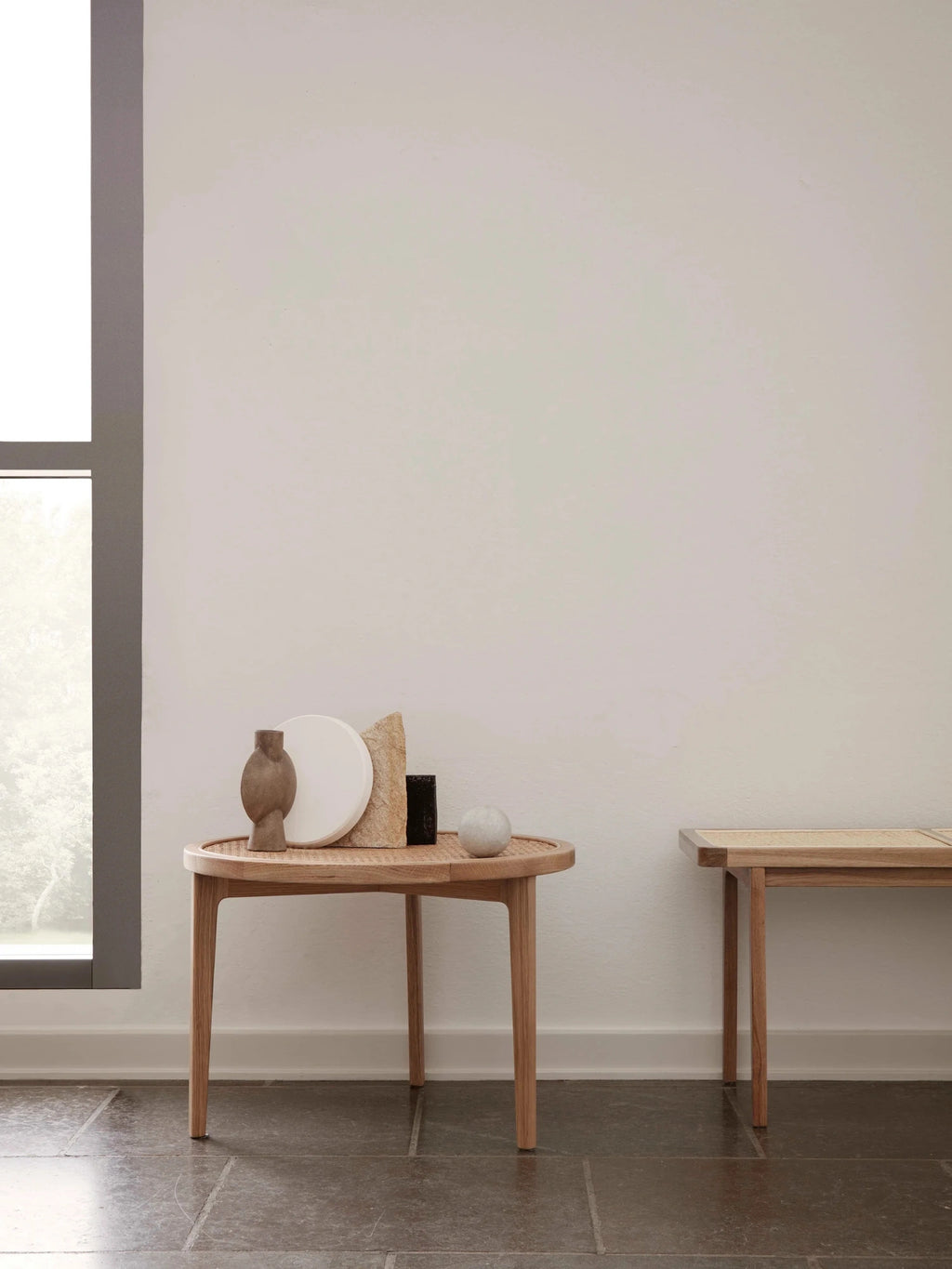 NORR11 Le Roi Coffee Table, a modern minimalist coffee table crafted from light natural oak wood with a beautifully curved, slightly oval top featuring a hand-woven cane rattan surface. Its clean lines, organic shape, and warm materials make it a perfect Scandinavian side table or japandi accent table for contemporary living rooms or bedrooms.