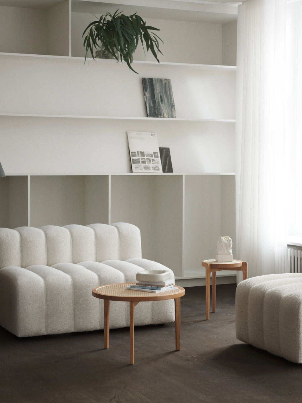 NORR11 Le Roi Coffee Table, a round Scandinavian coffee table crafted from light solid oak wood featuring a natural hand-woven cane rattan top and three slender, tapered legs. Its minimalist design and organic materials create a warm, inviting aesthetic. This natural wood coffee table is perfect for modern living rooms, japandi interiors, or as a stylish accent in contemporary spaces.
