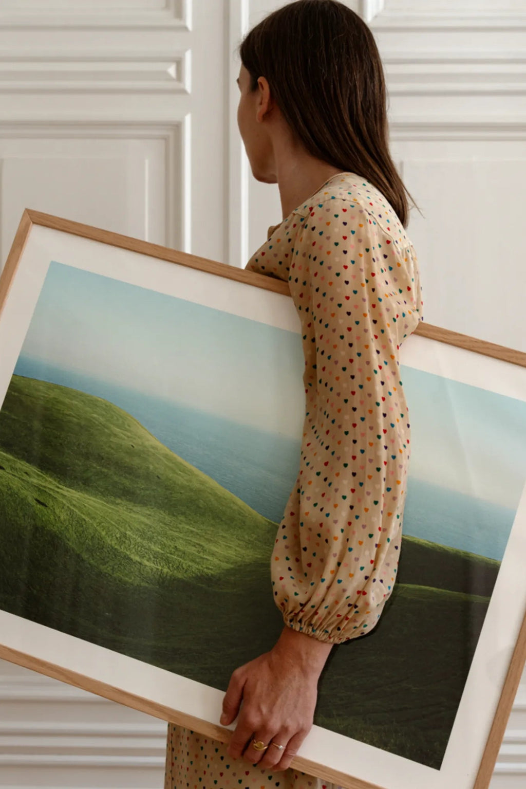 Woman holding Dorset handbag in cognac color, showcasing its spacious interior and multiple compartments