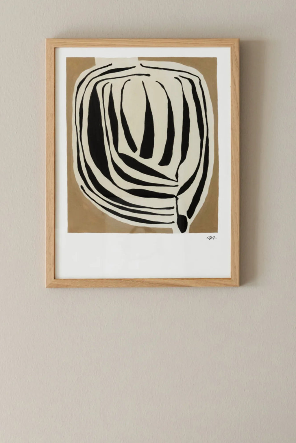 The Poster Club Layered, an abstract art print featuring bold, organic black shapes layered over a creamy background and a warm beige block, framed in a light natural oak frame with a white mat. This minimalist wall art piece is perfect for contemporary living rooms, organic modern bedrooms, or as a striking addition to a gallery wall.