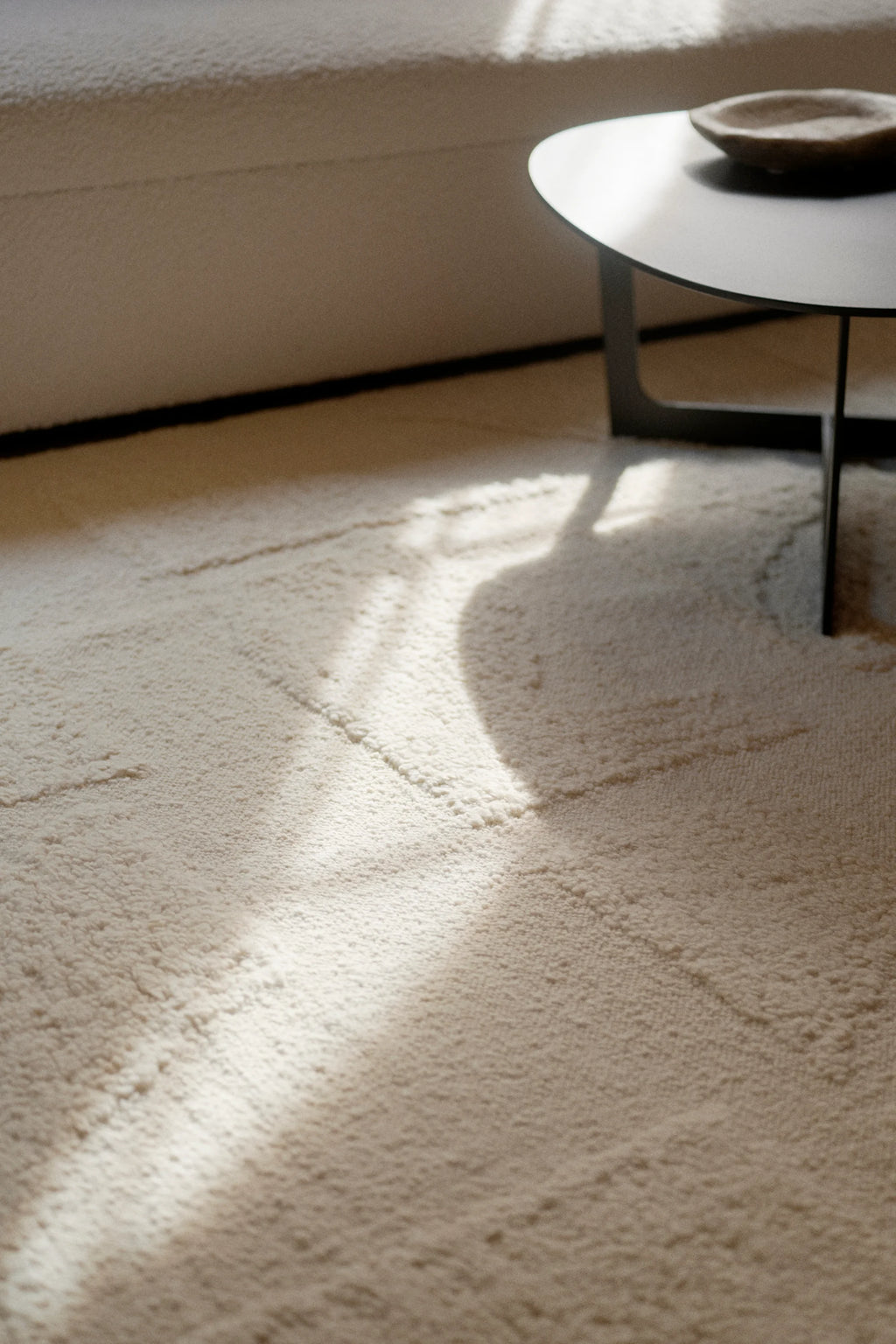 Linie Design Polar Angels Wool Rug, a plush hand-knotted wool area rug in a natural cream color with a soft, textured high pile. It features subtle raised linear patterns that create an organic modern aesthetic, blending warmth and minimalist design. This neutral wool rug is perfect for adding cozy comfort to Scandinavian living rooms, minimalist bedrooms, or contemporary spaces.
