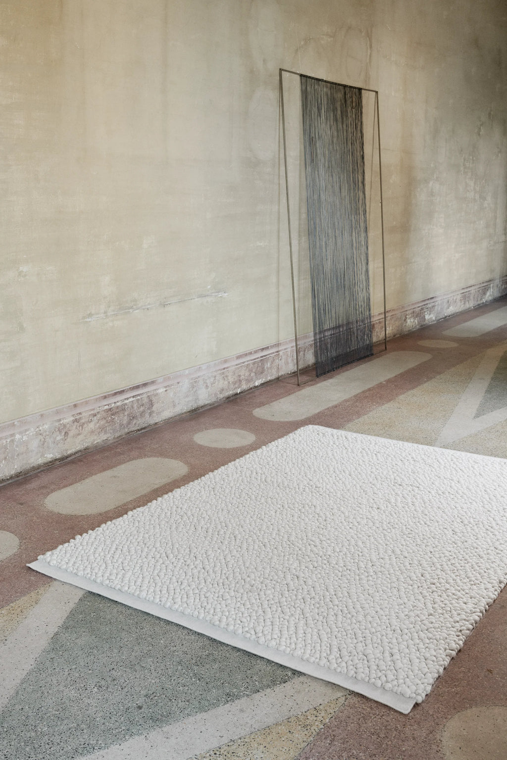 Linie Design Sigga Rug, a natural white hand-knotted wool area rug featuring a dense, highly textured bobbled pile, creating an organic, pebble-like surface with a soft, cozy feel. This minimalist Scandinavian rug is perfect for adding warmth and tactile interest to modern living rooms, bedrooms, or hygge-inspired spaces.