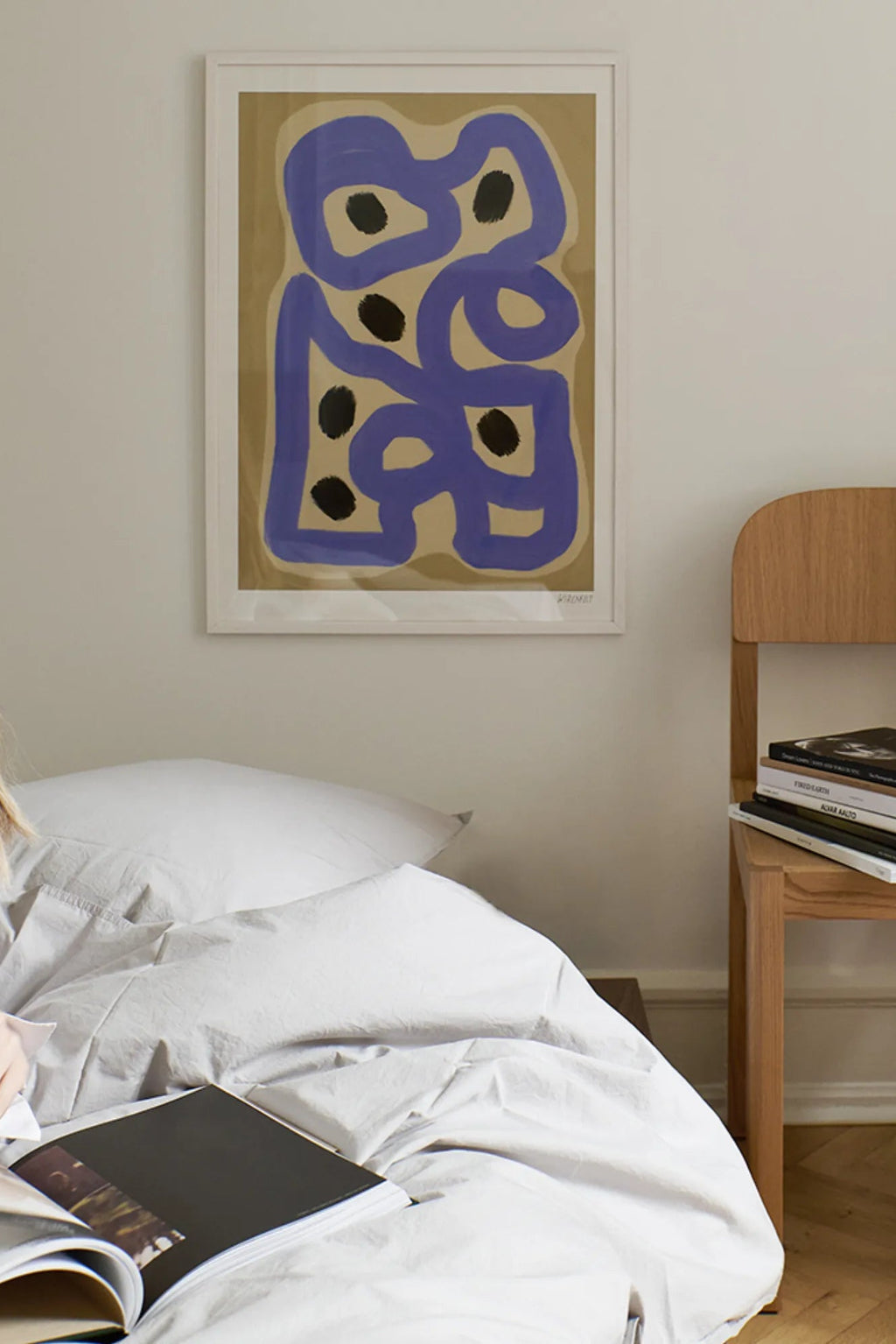 The Poster Club Signe, a contemporary abstract art print featuring bold organic lavender purple shapes and irregular black dots against a muted tan background, presented in a clean white frame.