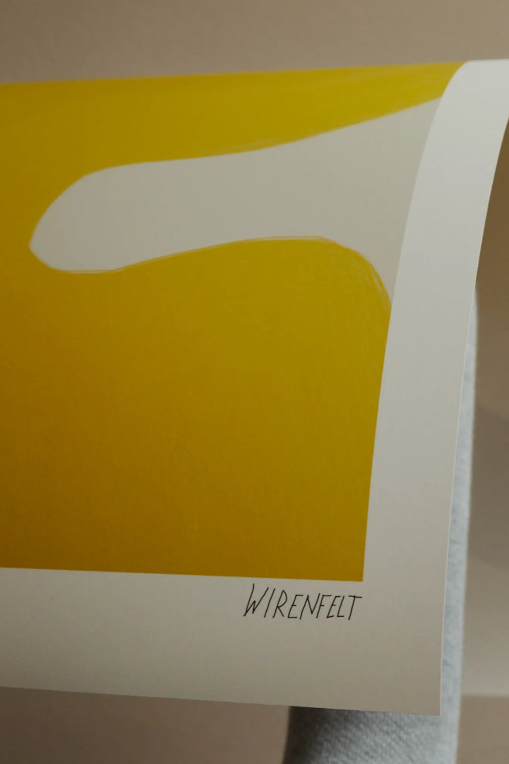 The Poster Club Solero, a vibrant abstract art print by Wirenfelt featuring a bold, organic off-white shape set against a rich mustard yellow background on high-quality paper.