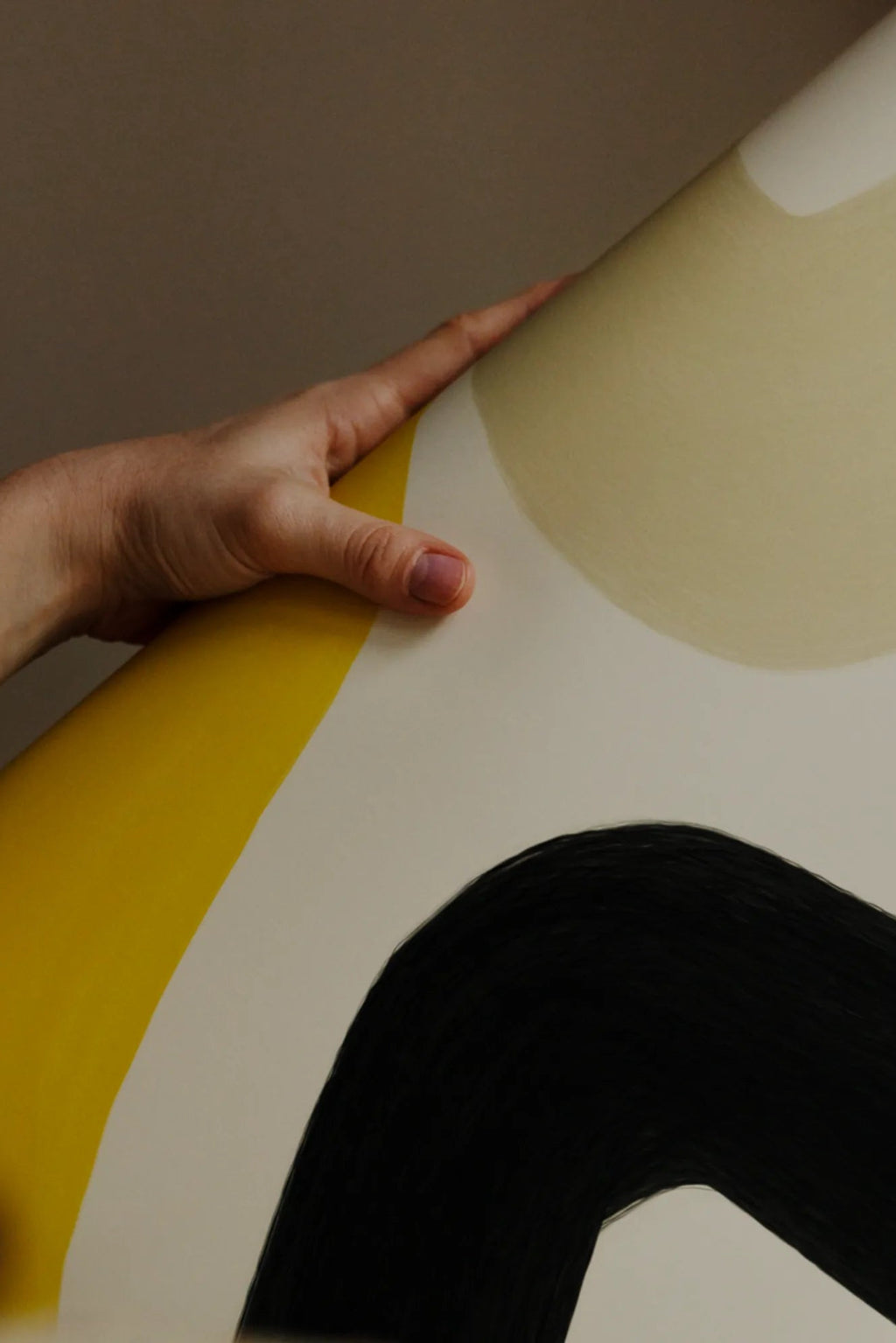 The Poster Club Solero, an abstract art print featuring bold, organic curved shapes in a striking color palette of matte black, bright yellow, and pale beige against a light cream background. The dramatic black shape exhibits a distinct brushstroke texture, adding depth to the modern design. Ideal as contemporary wall art for gallery walls in modern minimalist living rooms or creative studio spaces.