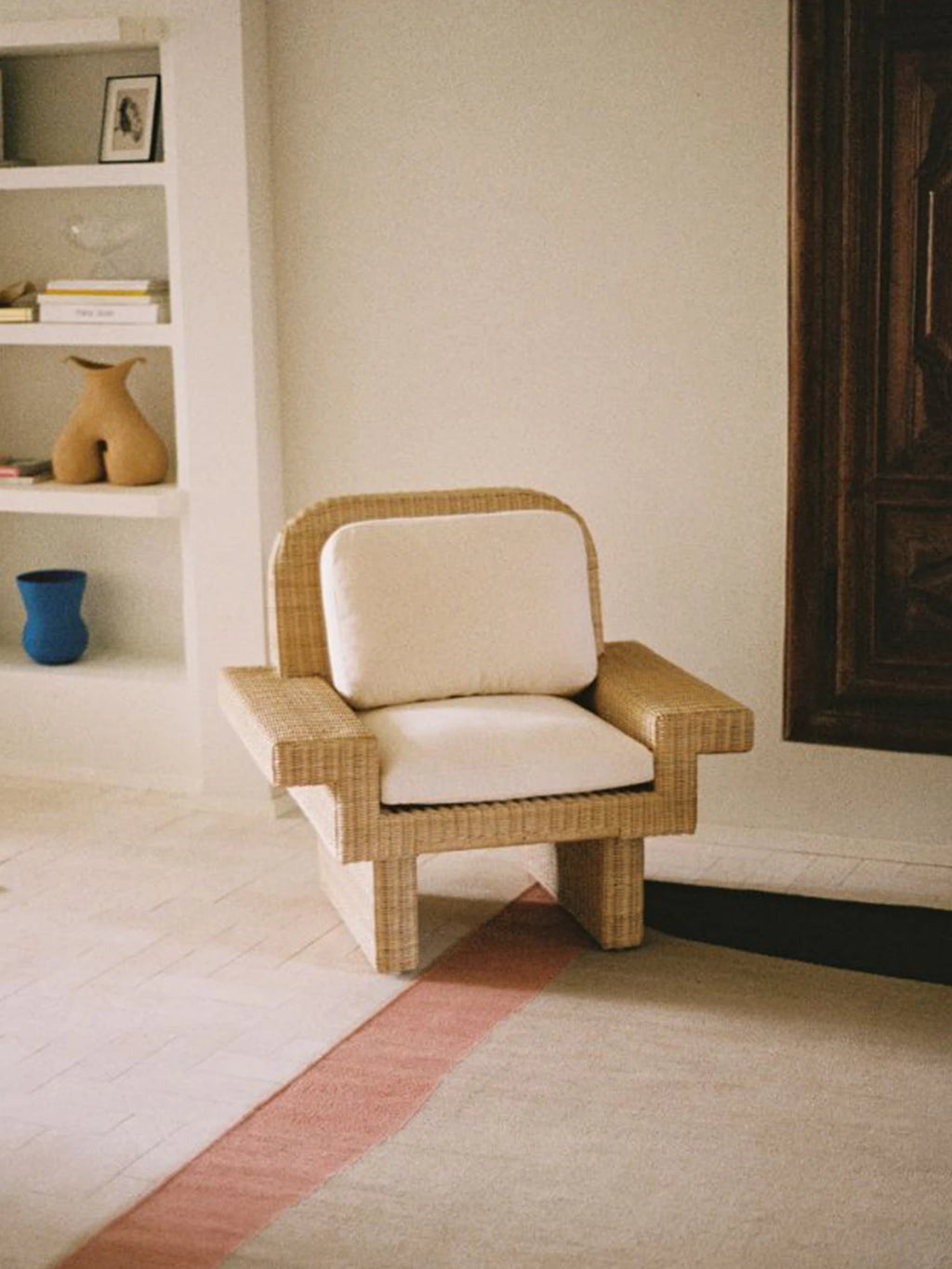 Heaps & Woods Louis Lounge Chair w/ Armrest, a contemporary organic modern lounge chair crafted from natural woven rattan with a distinctive blocky silhouette and wide armrests, complemented by plush cream fabric cushions.