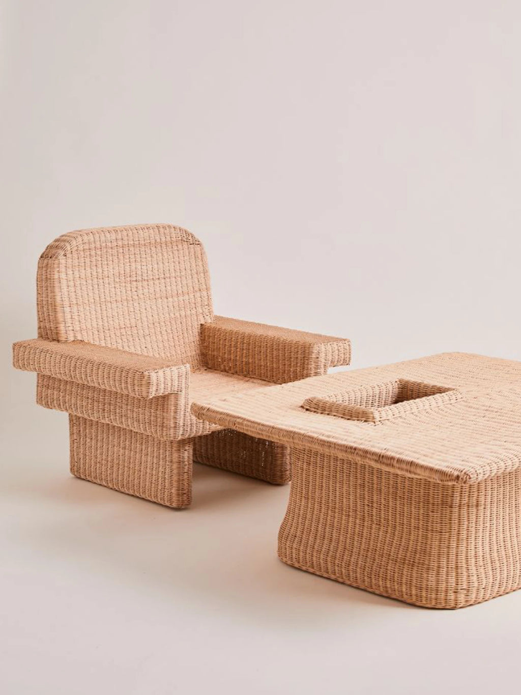 Heaps & Woods Louis Lounge Chair w/ Armrest, a chunky organic modern lounge chair crafted from natural woven rattan in a warm beige tone, featuring a distinctive geometric silhouette with a high rounded back and.