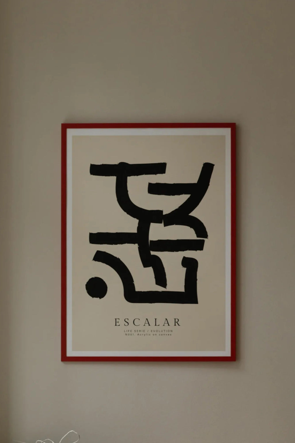 The Poster Club Escalar, a striking modern minimalist abstract art print featuring bold black graphic brushstroke shapes against a soft cream background, framed with a clean white mat and a vibrant red frame. This contemporary wall art is perfect for adding a pop of color to a gallery wall, living room, or modern bedroom decor.