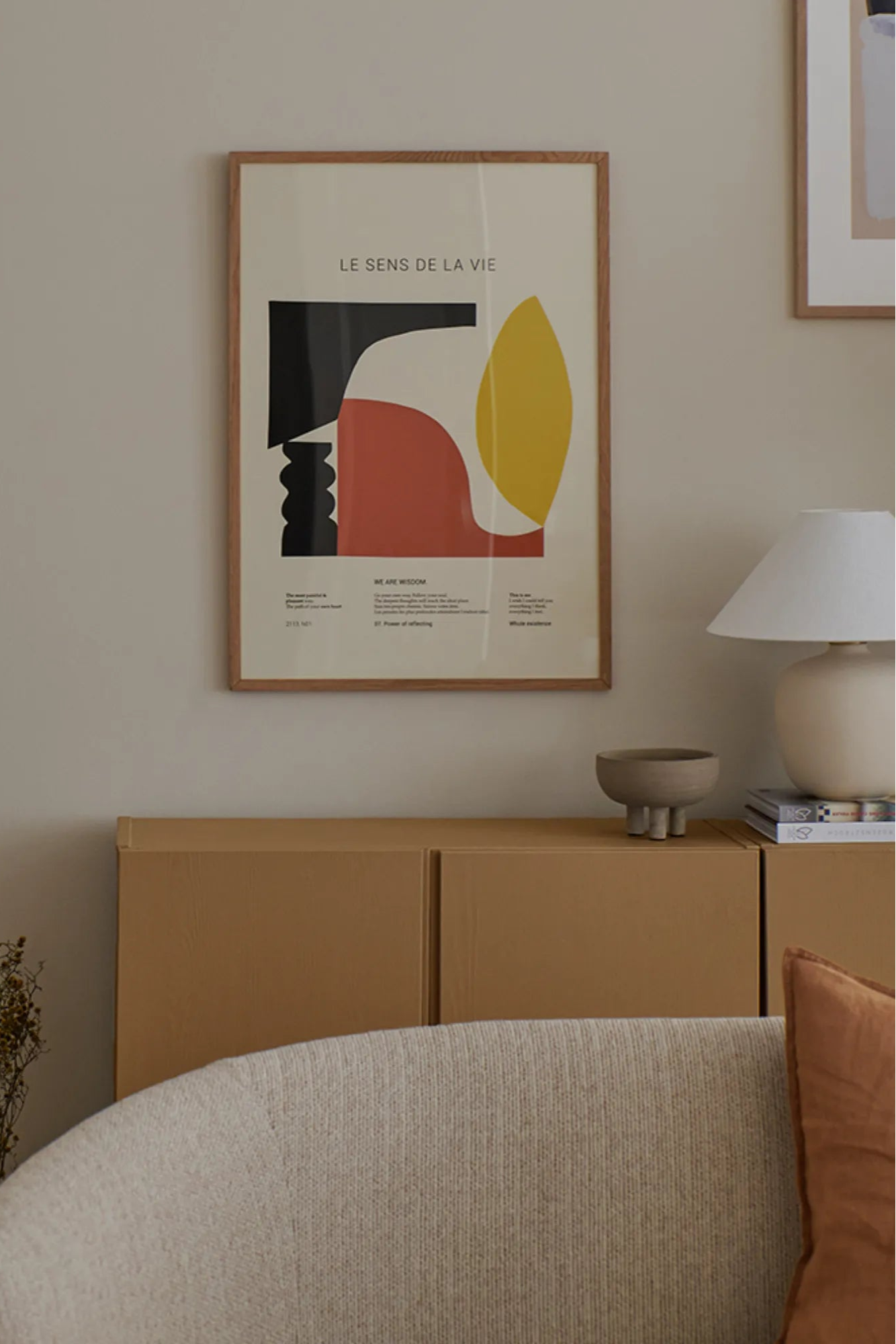 Woman's hand holding Le Sens De La Vie perfume bottle with soft lighting and luxurious background