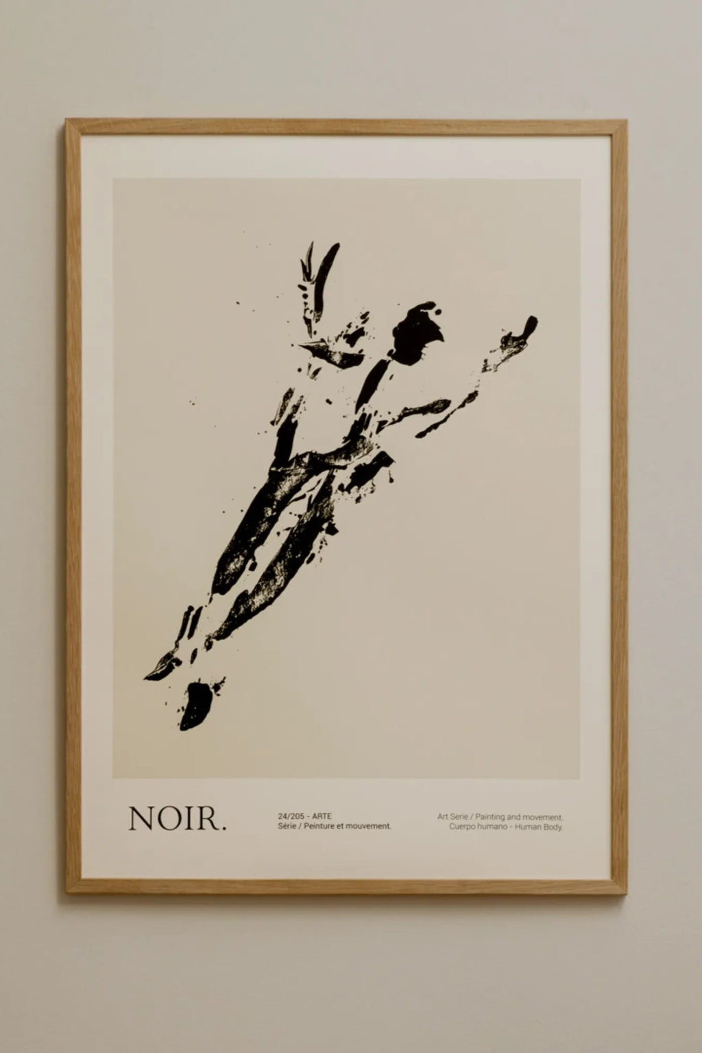 The Poster Club Noir, an abstract art print featuring a dynamic black ink figure suggesting human movement, set against a warm off-white background with subtle splatters and brushstroke texture. This minimalist design is presented in a light natural oak frame with a crisp white mat. Perfect for contemporary gallery walls, Scandinavian living rooms, or modern minimalist bedrooms seeking expressive wall art.