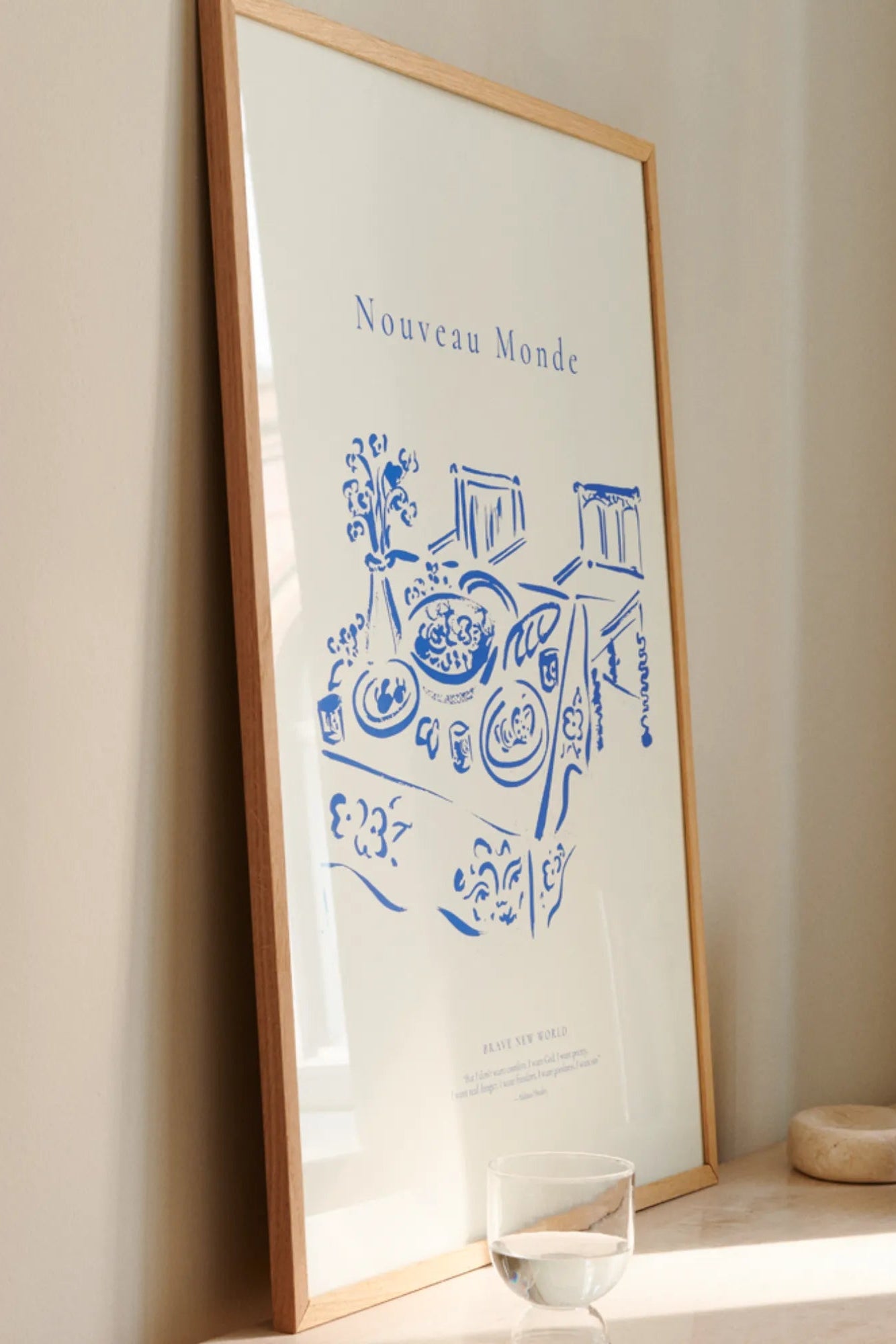 Close-up of the intricate stitching and embossed logo on the Nouveau Monde leather wallet