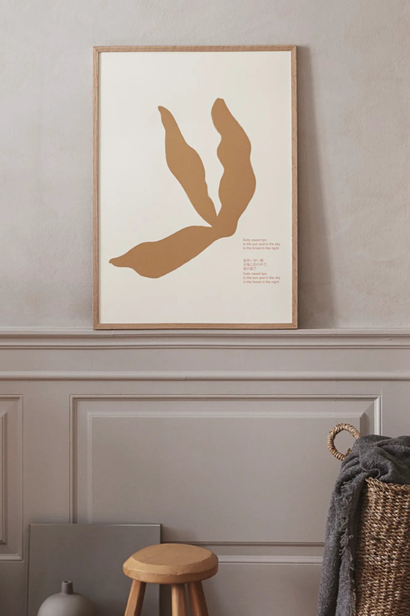 Close-up of hand holding jar of Salty Lips lip scrub with ocean background