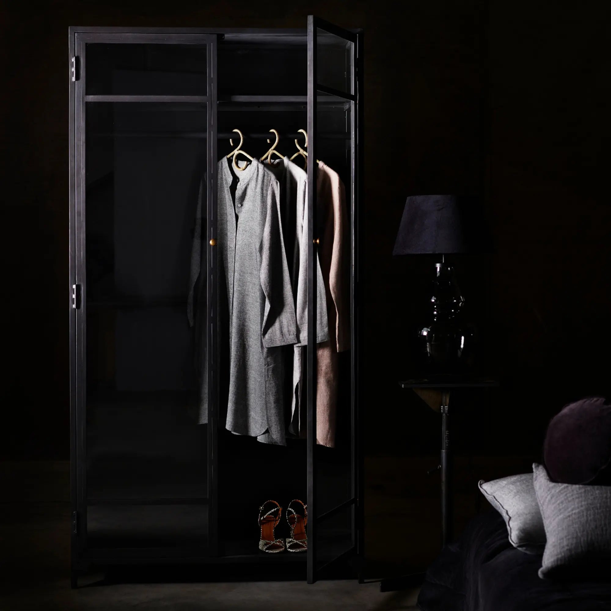 Large metal wardrobe with multiple shelves and hanging rod for clothes