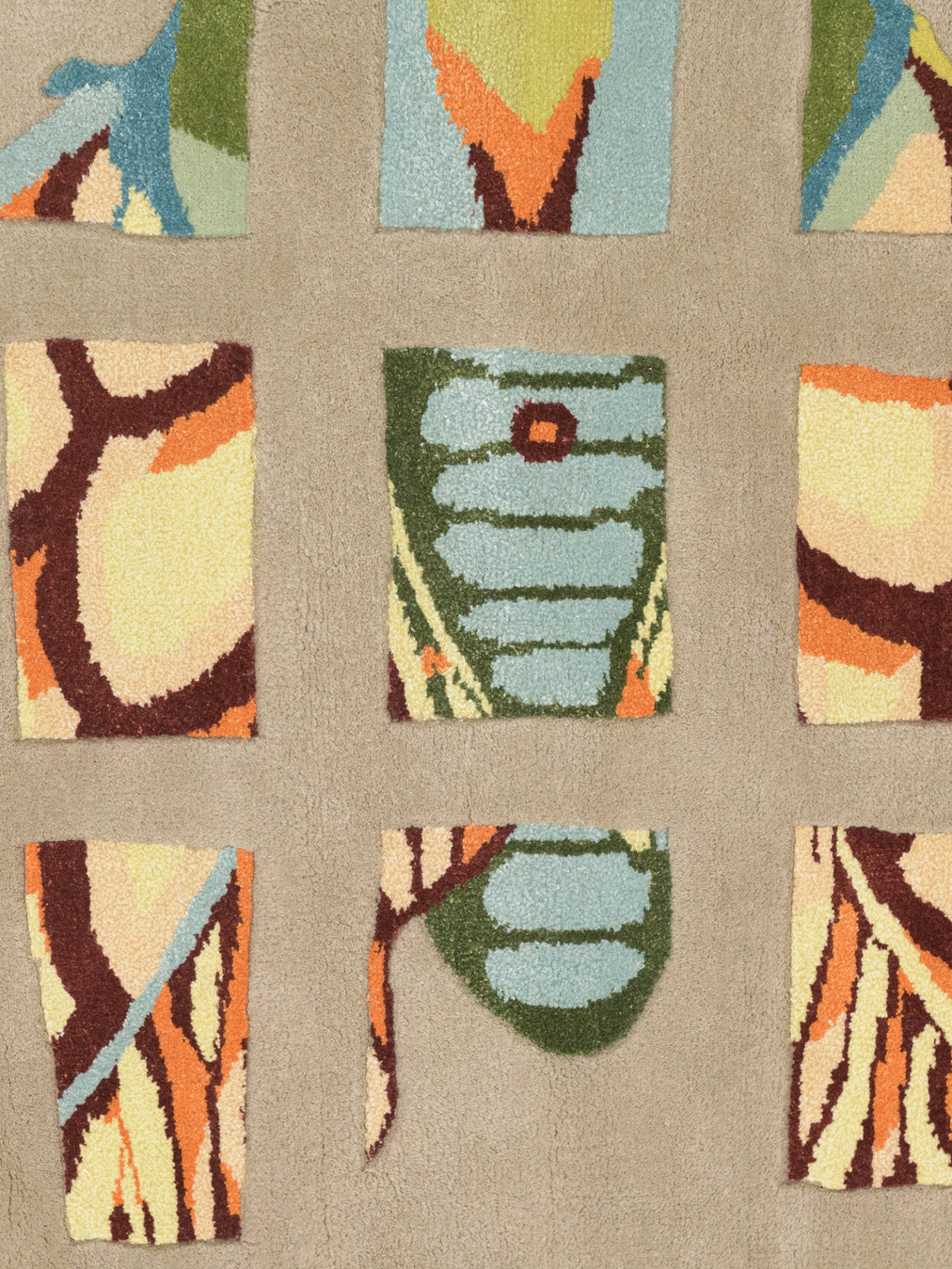 Haus Üger Moth Rug, a contemporary hand-tufted wool rug featuring an abstract, nature-inspired design with colorful moth wing patterns.