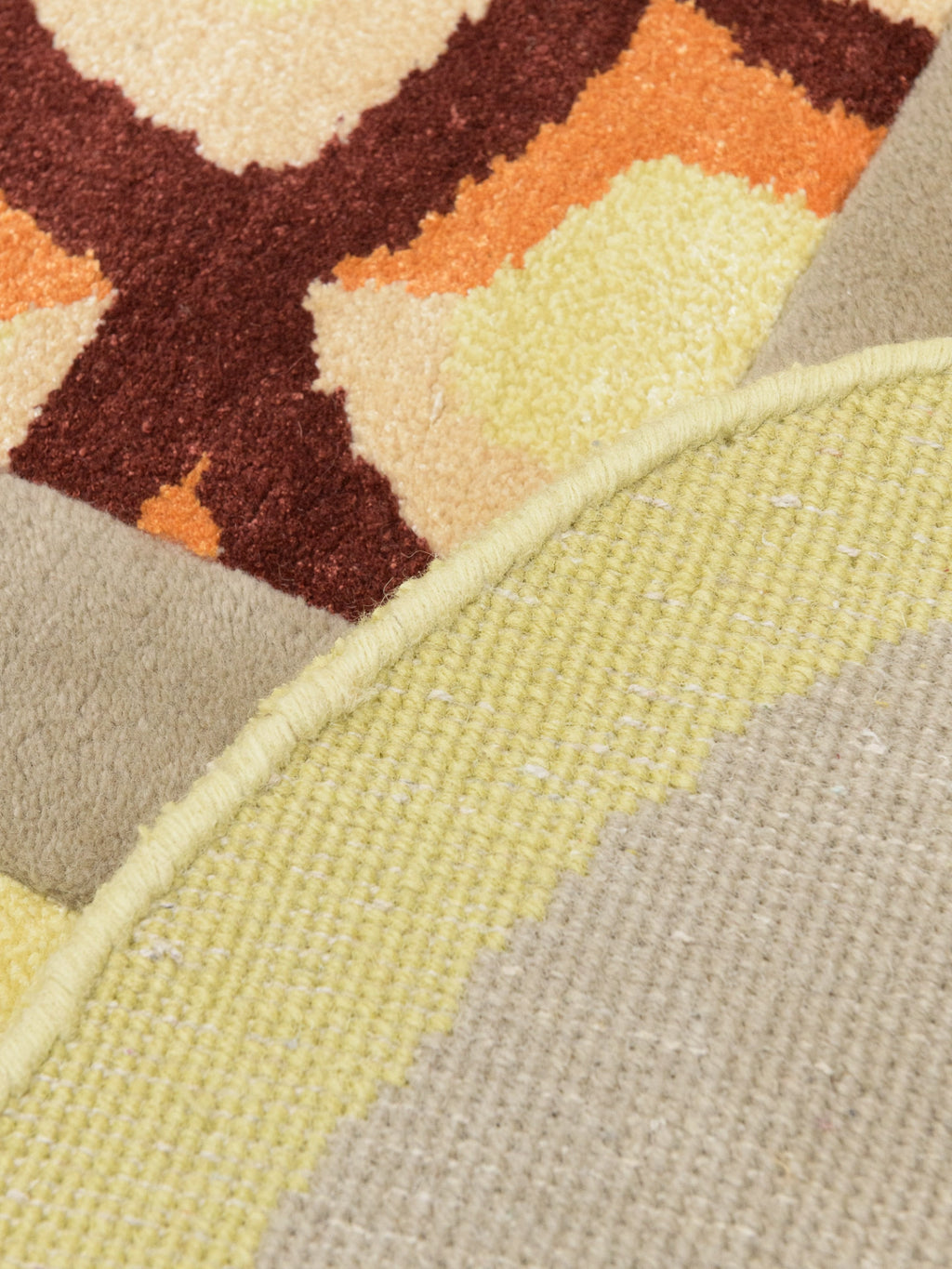 Haus Üger Moth Rug, an abstract organic modern area rug showcasing a captivating blend of textures and colors, featuring plush hand-tufted wool in rich brown, warm orange, and creamy yellow.