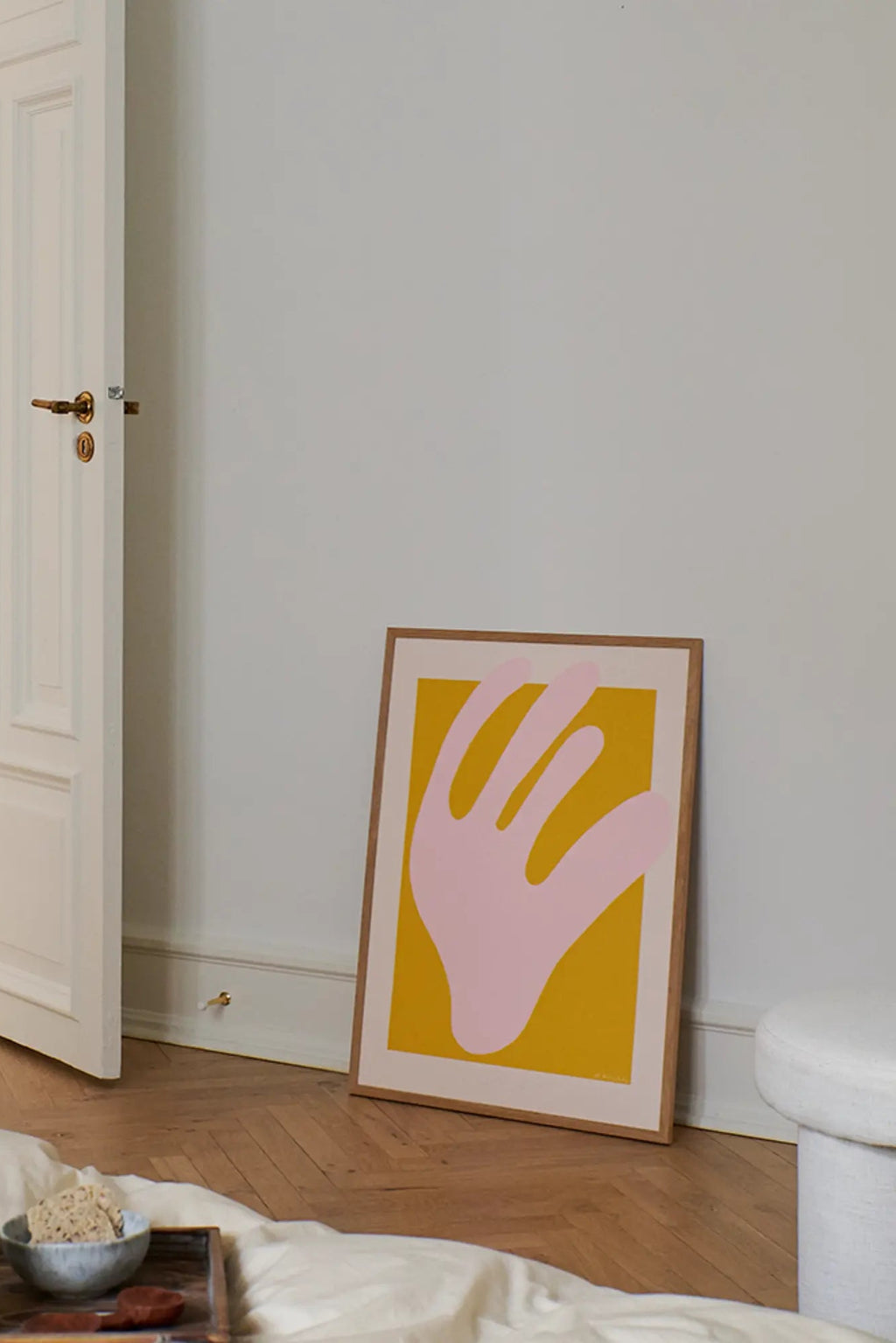 The Poster Club Pink Coral, an abstract art print featuring an organic light pink coral shape against a vibrant golden yellow background, framed with a crisp white mat and a natural oak frame. This contemporary poster is perfect as modern wall art for minimalist gallery walls, creative studio spaces, or a pop of color in Scandinavian bedrooms.