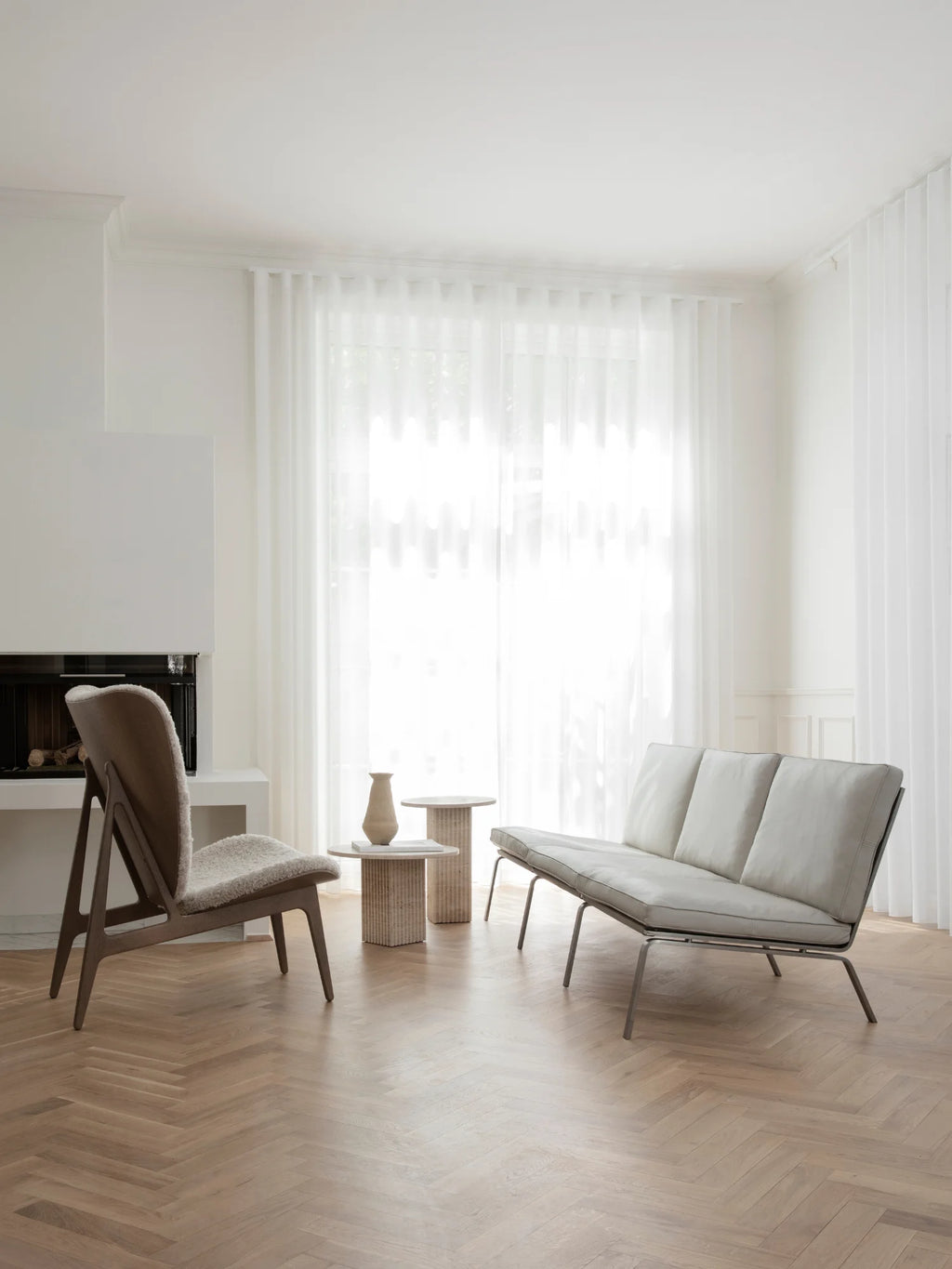 NORR11 Man 3 Seater Sofa, a contemporary low profile sofa featuring light grey leather upholstery with three plush cushions and a distinctive exposed slim metal frame. This modern minimalist design offers a relaxed lounge aesthetic, perfect for sophisticated living rooms or Scandinavian-inspired spaces.