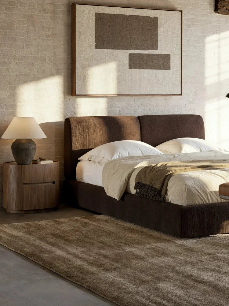 Domkapa Margot Plus Bed, a contemporary upholstered bed featuring a rich dark brown ribbed fabric on both the platform frame and the plush two-panel headboard, offering a cozy and inviting aesthetic. This modern minimalist bed is ideal for master bedrooms seeking warm, organic modern design and exceptional comfort.