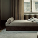  Sleek and versatile mass daybed in beige fabric with wooden frame and bolster cushions for relaxation 