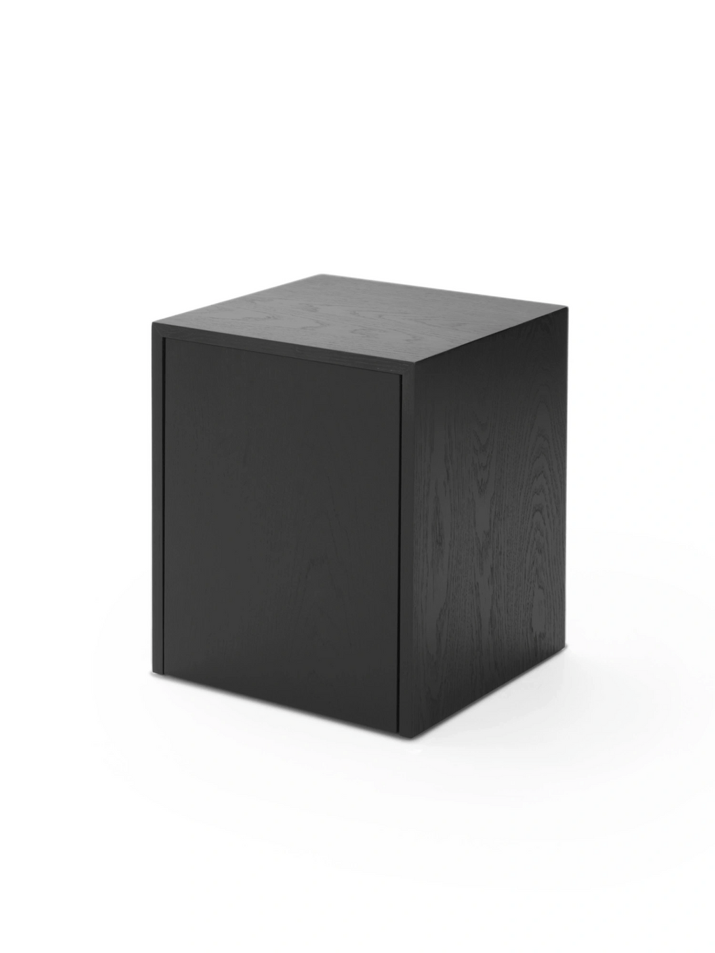 New Works Mass Side Table w. Drawer, a sleek, modern minimalist cube side table crafted from black stained wood with a subtle visible grain texture and a smooth matte finish. This contemporary design features a hidden integrated drawer, offering discreet storage solutions. Ideal as a black nightstand for a modern bedroom or a stylish accent table for a Scandinavian living room.