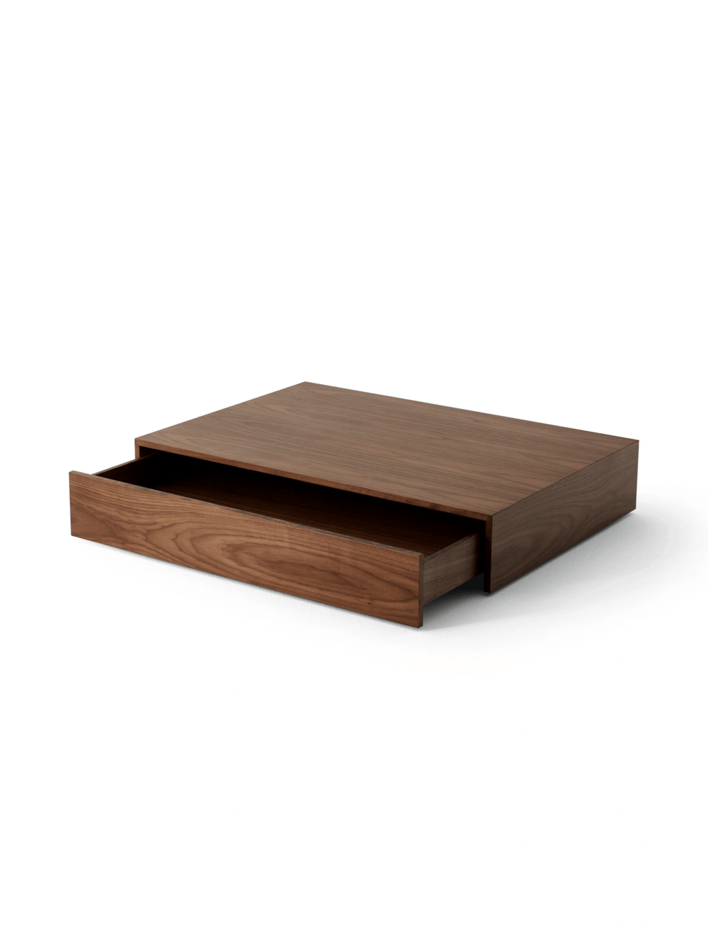 New Works Mass Coffee Table w. Drawer, a sleek, low-profile modern minimalist coffee table crafted from rich dark walnut wood, featuring clean lines and a smooth, visible wood grain. It includes a discreet integrated drawer for hidden storage, making it both functional and aesthetically pleasing. Ideal for contemporary living rooms, Scandinavian interiors, or any space seeking a sophisticated dark wood accent.