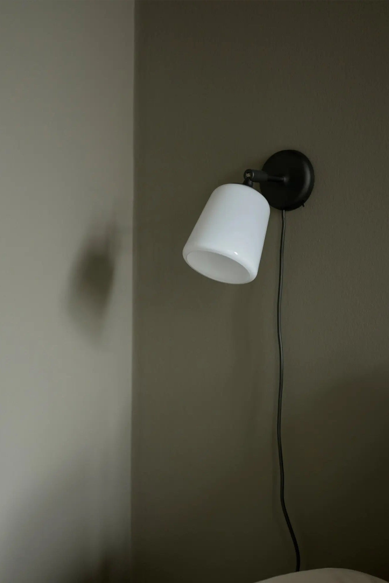 Modern matte black material wall lamp with adjustable arm and integrated LED lighting