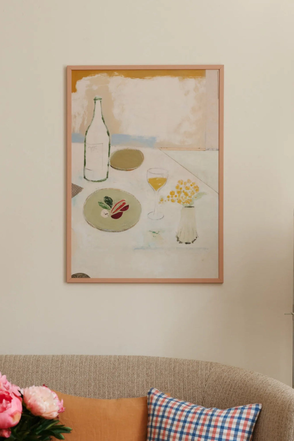 The Poster Club Fleurs Jaunes, an abstract still life art print featuring a painterly depiction of a dining table scene with a wine bottle, glass, plate of food, and a vase of yellow flowers. Rendered in a soft, muted pastel palette of cream, olive green, pale blue, and warm yellow, this contemporary wall art is framed in a slender peachy-pink frame. Ideal for modern dining rooms, minimalist living spaces, or organic modern gallery walls.