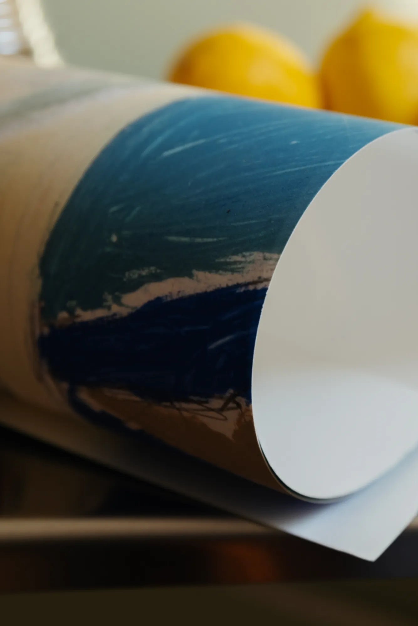 Table 8 L’Auberge: Top view of the round dining table with a rich, dark wood finish