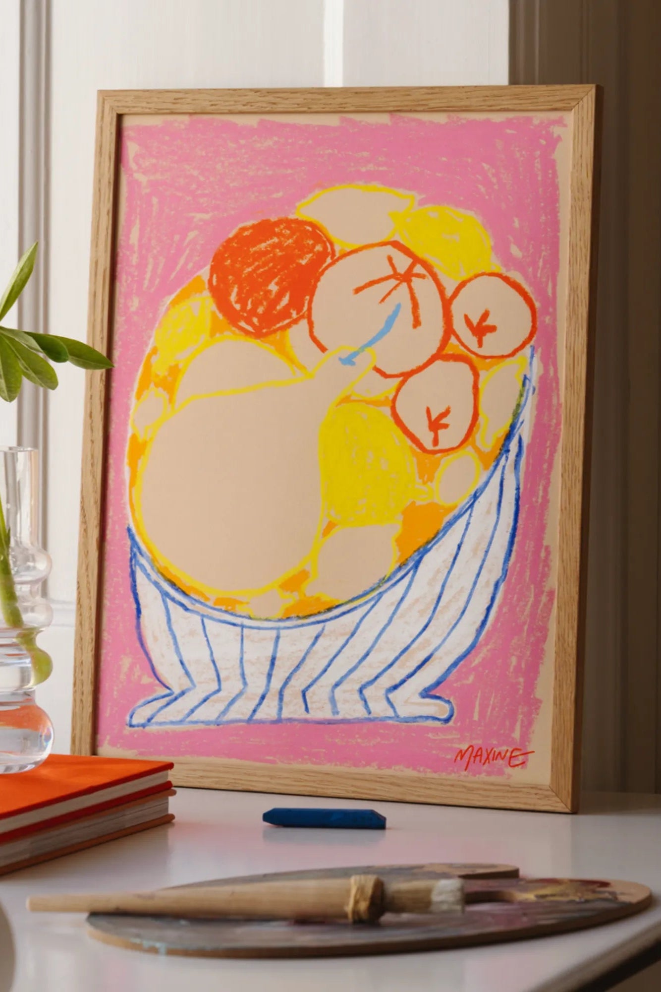 A decorative fruit bowl containing a variety of colorful and healthy fruits on a pink tabletop