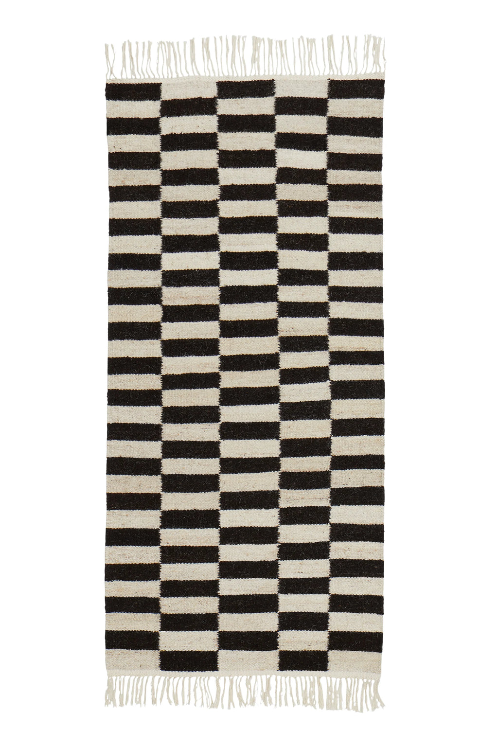 Sera Helsinki Abeba Rug, a hand-woven wool area rug featuring a striking black and off-white geometric pattern of alternating horizontal stripes forming a checkerboard design, with natural fringed ends. The thick, textured weave offers a cozy feel in undyed wool tones. Perfect as a modern minimalist or Scandinavian rug for living rooms, bedrooms, or entryways.